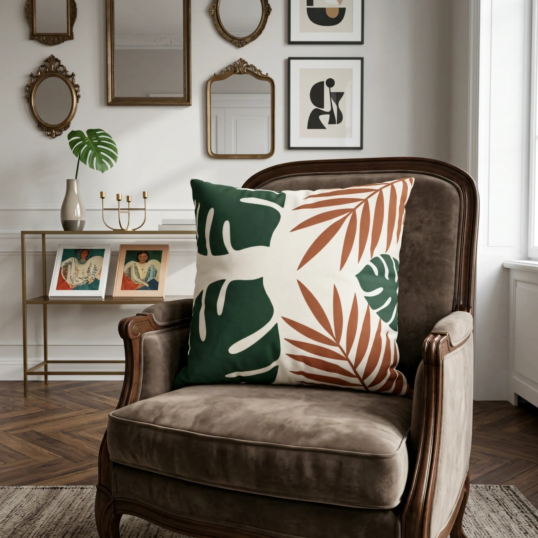Decorative pillow featuring green monstera and terracotta leaf patterns on a brown vintage armchair in an elegant living room setting.