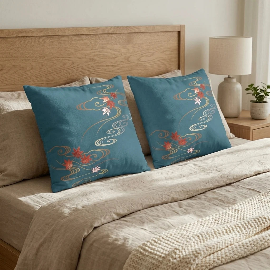 Teal blue decorative pillows with Japanese maple leaf patterns on a beige bed with a wooden headboard in a minimalist bedroom setting.